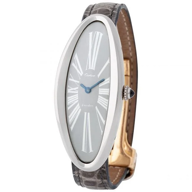 Oval Cartier London watch with grey dial, blue hands, diamond crown, and grey alligator strap.