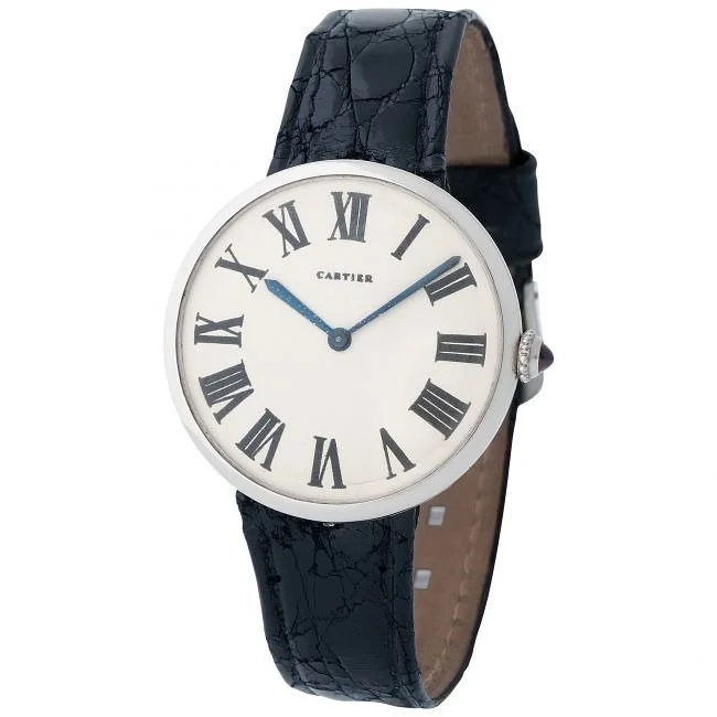 Vintage Cartier watch: platinum case, white dial, black Roman numerals, blue hands, dark leather strap.