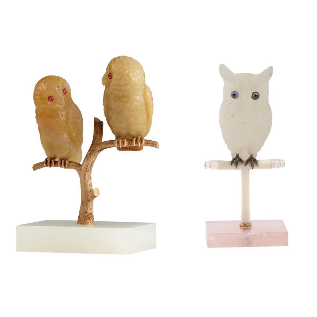 Carved stone owl figurines: two amber owls with ruby eyes, one white owl with sapphire eyes.
