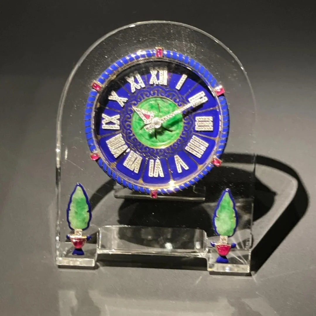 Art Deco crystal clock with blue enamel, diamond numerals, rubies, and green jade details.
