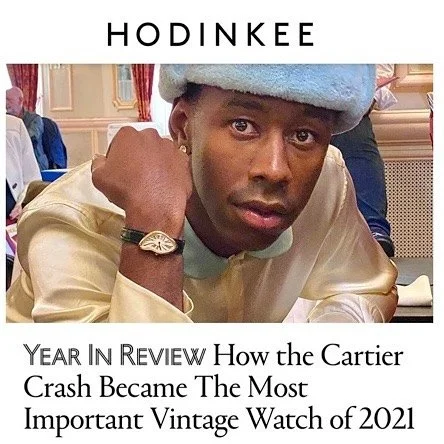 Man in light blue hat and cream shirt wearing a gold Cartier Crash watch.