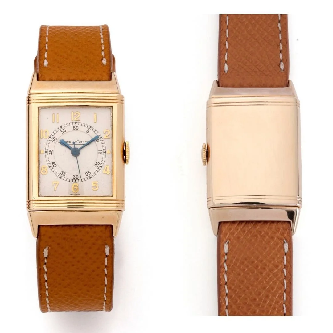 Gold rectangular Jaeger-LeCoultre Reverso watch with light dial, blue hands, brown leather strap.